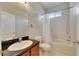 Well-lit bathroom with a vanity and a shower-tub combination with a white shower curtain at 21744 Waverly Shores Ln, Land O Lakes, FL 34637