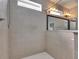 Modern tiled shower with handheld sprayer and large mirror reflecting bathroom vanity at 21744 Waverly Shores Ln, Land O Lakes, FL 34637