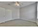 Bright bedroom featuring neutral carpet, a ceiling fan, and a large closet at 21744 Waverly Shores Ln, Land O Lakes, FL 34637