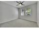 Bright bedroom with neutral walls, carpet, a ceiling fan, and two large windows at 21744 Waverly Shores Ln, Land O Lakes, FL 34637