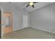 Bedroom with neutral walls, carpet, ceiling fan, closet, and access to bathroom at 21744 Waverly Shores Ln, Land O Lakes, FL 34637