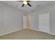 Bedroom with neutral carpet, a ceiling fan, double closet, and ensuite bathroom at 21744 Waverly Shores Ln, Land O Lakes, FL 34637