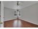 Bright bedroom with hardwood floors, ceiling fan, and large windows with blinds at 21744 Waverly Shores Ln, Land O Lakes, FL 34637