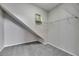 Walk-in closet with neutral carpeting, wire shelving, and sloped ceiling at 21744 Waverly Shores Ln, Land O Lakes, FL 34637