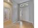 Bright foyer with hardwood floors, white front door with sidelight, and hallway to bathroom at 21744 Waverly Shores Ln, Land O Lakes, FL 34637