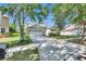 Inviting single-Gathering home with stone accents, a two-car garage, and a lush, green lawn at 21744 Waverly Shores Ln, Land O Lakes, FL 34637