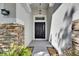 Inviting front porch featuring a stylish front door and stone detailing on the exterior at 21744 Waverly Shores Ln, Land O Lakes, FL 34637
