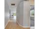 Hallway with wood floors leading to a living room with hardwood floors and fireplace at 21744 Waverly Shores Ln, Land O Lakes, FL 34637