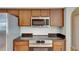 Close up of the kitchen range, showcasing its stainless steel appliances and solid surface counter at 21744 Waverly Shores Ln, Land O Lakes, FL 34637