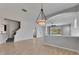 Open-concept living room with staircase, view to other rooms, and a pendant light at 21744 Waverly Shores Ln, Land O Lakes, FL 34637
