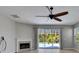 Bright living room featuring a fireplace and sliding glass doors to the pool at 21744 Waverly Shores Ln, Land O Lakes, FL 34637