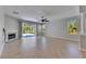 Spacious living room with fireplace, sliding glass doors to screened lanai, and large windows at 21744 Waverly Shores Ln, Land O Lakes, FL 34637