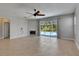 Spacious living room with tile floors, fireplace, and access to the pool area at 21744 Waverly Shores Ln, Land O Lakes, FL 34637