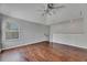Spacious living room with hardwood floors, ceiling fan, and large windows at 21744 Waverly Shores Ln, Land O Lakes, FL 34637