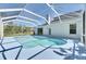 Backyard featuring a screened-in pool area and a beautiful view of the surrounding landscape at 21744 Waverly Shores Ln, Land O Lakes, FL 34637