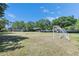 A community soccer field with two goals sitting on a mostly bare green grass field under a blue sky at 21744 Waverly Shores Ln, Land O Lakes, FL 34637
