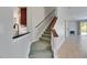 Carpeted staircase next to kitchen with view to living room and fireplace at 21744 Waverly Shores Ln, Land O Lakes, FL 34637