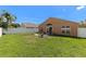 Private backyard featuring a white fence, well-maintained lawn, and a cozy fire pit area at 26850 Middleground Loop, Wesley Chapel, FL 33544