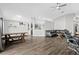 Open-concept living room featuring sleek wood flooring and a comfortable seating area at 26850 Middleground Loop, Wesley Chapel, FL 33544