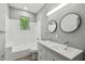 Well-lit bathroom with a double sink vanity, tub-shower, and modern fixtures at 3411 N 12Th St, Tampa, FL 33605