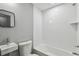Minimalist bathroom with white tile, modern fixtures, and simple design at 3411 N 12Th St, Tampa, FL 33605