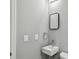 Stylish bathroom with a modern, square sink, square mirror, and sleek fixtures at 3411 N 12Th St, Tampa, FL 33605