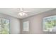 Bright bedroom featuring neutral walls, blinds on the windows, and a ceiling fan at 3411 N 12Th St, Tampa, FL 33605