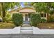 Charming bungalow-style home with lush trees, manicured shrubs, and a welcoming front entrance at 3411 N 12Th St, Tampa, FL 33605