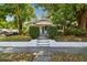 Charming bungalow-style home with lush trees, manicured shrubs, and a welcoming front entrance at 3411 N 12Th St, Tampa, FL 33605
