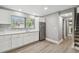 Contemporary kitchen with stainless steel refrigerator, white cabinets, and wood-look flooring at 3411 N 12Th St, Tampa, FL 33605
