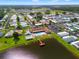 Beautiful aerial shot of community with central clubhouse, pool, shuffleboard, pond, and well-maintained homes at 34150 Estates Ln, Wesley Chapel, FL 33543