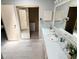 A bathroom with blue walls, a single sink, large mirror, and gray flooring at 34150 Estates Ln, Wesley Chapel, FL 33543