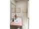 Bathroom featuring floral wallpaper, pink counters, and a single sink at 34150 Estates Ln, Wesley Chapel, FL 33543