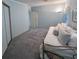 A bedroom featuring neutral blue walls, carpet, and a white daybed with pillows at 34150 Estates Ln, Wesley Chapel, FL 33543