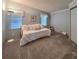 Bedroom featuring a white daybed with many pillows, as well as two windows and neutral carpeting at 34150 Estates Ln, Wesley Chapel, FL 33543