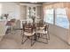 Dining area boasting a stylish table setting, built-in cabinet, and natural light from the adjacent window at 34150 Estates Ln, Wesley Chapel, FL 33543