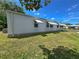 Exterior view of the home featuring awnings for shade and a comfortable living space at 34150 Estates Ln, Wesley Chapel, FL 33543