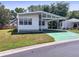 Inviting single-story home with a covered carport and well-maintained landscaping, offering comfort and convenience at 34150 Estates Ln, Wesley Chapel, FL 33543