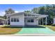 Charming single story home with a covered parking area, well-maintained lawn, and inviting curb appeal at 34150 Estates Ln, Wesley Chapel, FL 33543