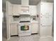 Functional kitchen featuring white appliances, ample cabinetry, and a clean, well-maintained layout at 34150 Estates Ln, Wesley Chapel, FL 33543