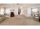 Comfortable living area with seating, neutral decor and a view into the kitchen and dining area at 34150 Estates Ln, Wesley Chapel, FL 33543