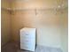 A walk-in closet featuring wall-mounted shelving and a white three-drawer dresser at 34150 Estates Ln, Wesley Chapel, FL 33543