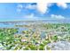 Stunning aerial view of the neighborhood with water and city skyline in the background at 3572 Pocahontas Dr, Largo, FL 33774