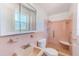 Retro bathroom featuring tile throughout, walk-in shower with grab bar, and a matching sink and toilet at 3572 Pocahontas Dr, Largo, FL 33774