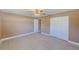 Bright bedroom featuring tile floors, neutral paint, baseboard trim, closet, and a ceiling fan at 3572 Pocahontas Dr, Largo, FL 33774