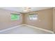Comfortable bedroom featuring tile floors, neutral paint, baseboard trim, two windows, and a ceiling fan at 3572 Pocahontas Dr, Largo, FL 33774