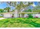 Charming home with a well-maintained lawn, flowers and a newer garage door at 3572 Pocahontas Dr, Largo, FL 33774