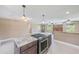 Kitchen island with stainless appliances, granite countertops, and opens to a living area at 3572 Pocahontas Dr, Largo, FL 33774