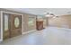 Spacious living room featuring a decorative fireplace, ceiling fans, and light tile floors at 3572 Pocahontas Dr, Largo, FL 33774