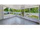 Screened patio provides an airy space with views of the backyard featuring a fire pit and a privacy fence at 3572 Pocahontas Dr, Largo, FL 33774
